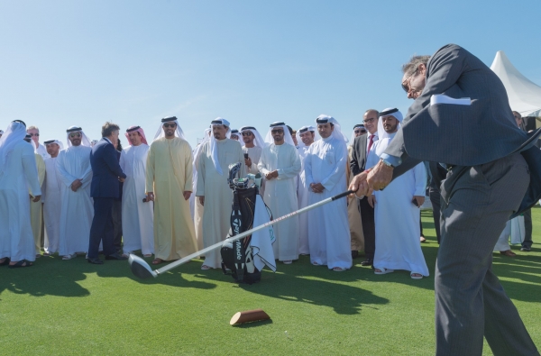 Mark Chapleski teeing off as HH Sheikh Humaid Al Nuaimi and Sheikh Rashid Al Nuaimi look on.jpg